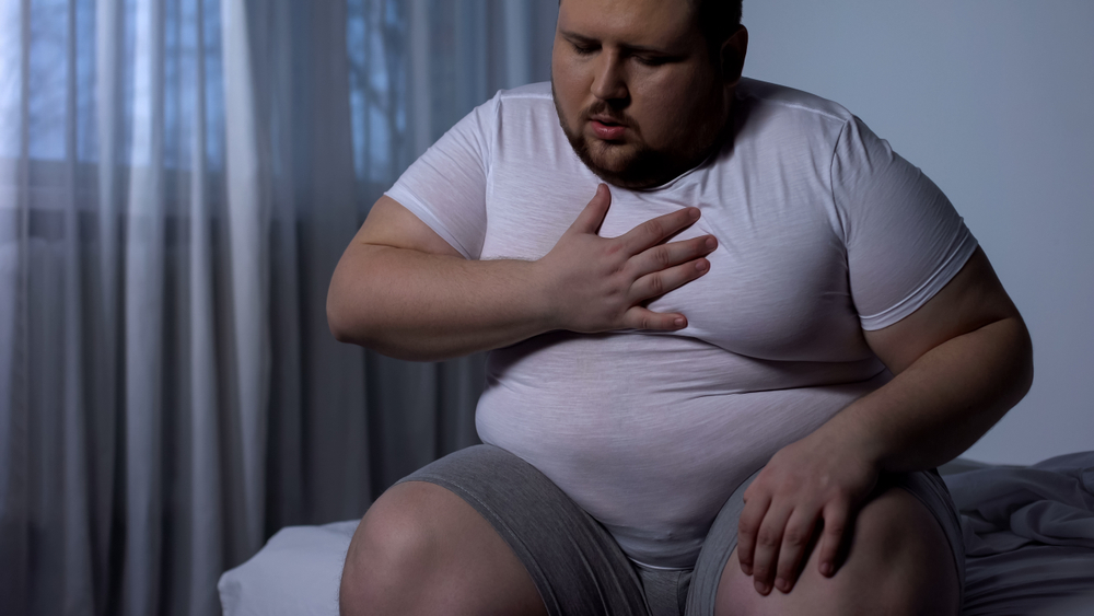 Overweight man feeling chest pain