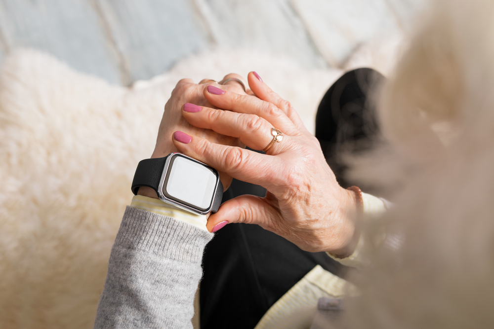 older woman looking at her smart watch.