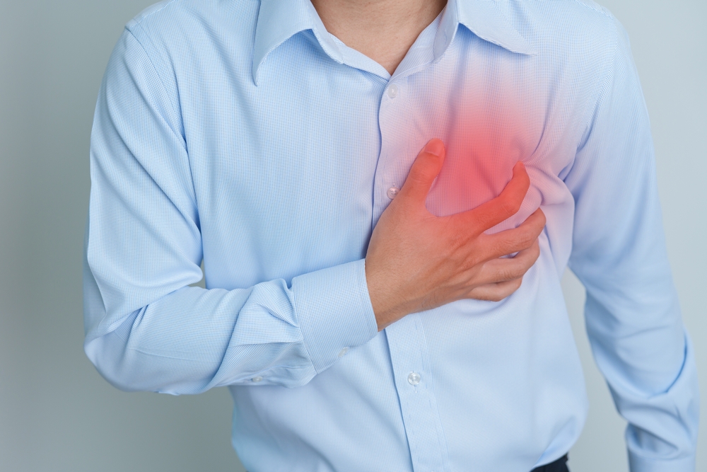 man holding chest in pain.